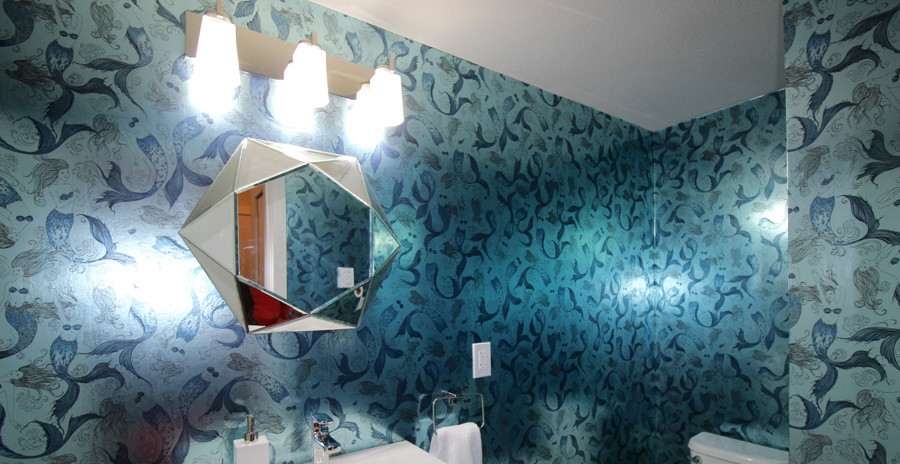 This is an example of a small bohemian cloakroom in Vancouver with a wall-mounted sink, flat-panel cabinets, white cabinets, a two-piece toilet, blue walls and ceramic flooring.