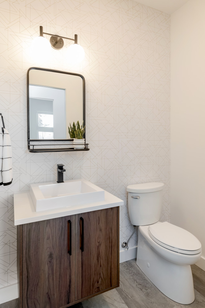 Cette photo montre un WC et toilettes rétro en bois brun de taille moyenne avec un placard à porte plane, WC séparés, un mur blanc, un sol en vinyl, une vasque, un plan de toilette en quartz modifié, un sol gris et un plan de toilette blanc.