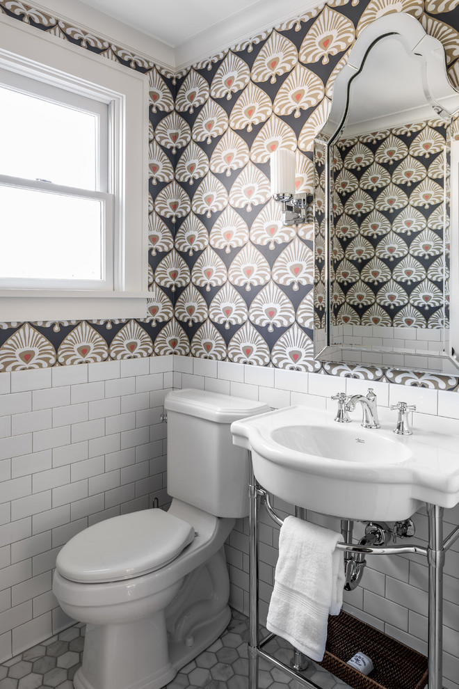 Inspiration for a timeless marble floor powder room remodel in Minneapolis with a two-piece toilet, multicolored walls and a console sink