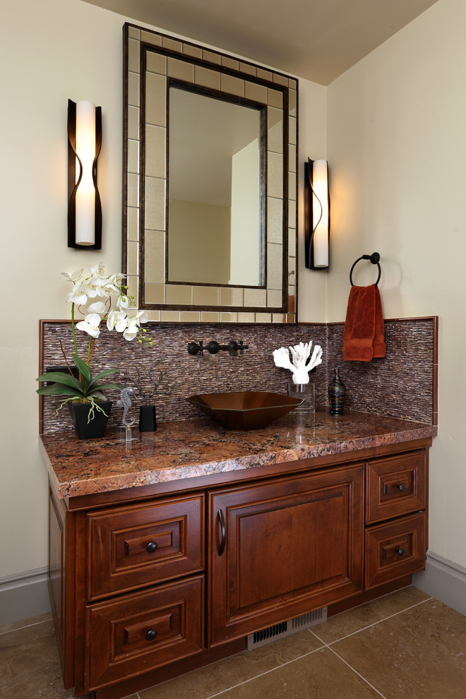 Powder room - huge contemporary brown tile travertine floor powder room idea in San Francisco with raised-panel cabinets, medium tone wood cabinets, granite countertops, a vessel sink and beige walls