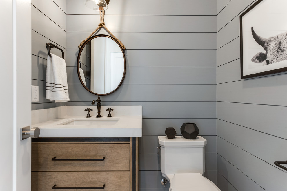 Example of a cottage powder room design in Salt Lake City with flat-panel cabinets, medium tone wood cabinets, gray walls, an undermount sink and white countertops
