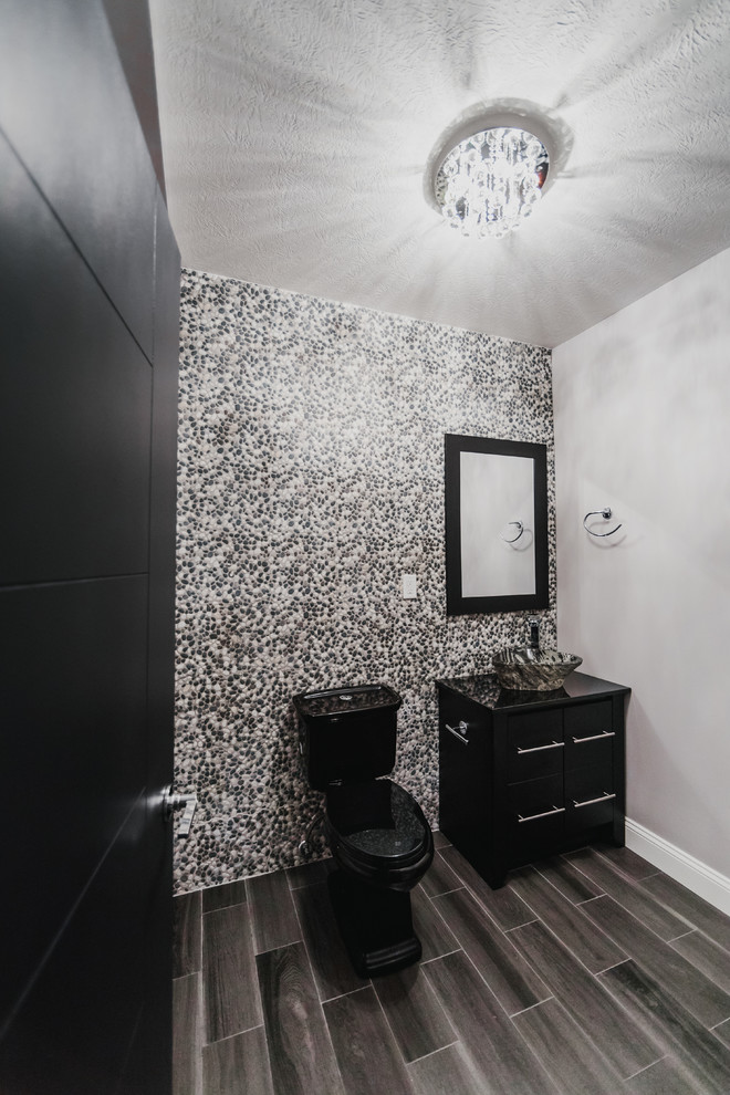 Photo of a large contemporary cloakroom in Other with flat-panel cabinets, black cabinets, a two-piece toilet, multi-coloured tiles, mosaic tiles, multi-coloured walls, porcelain flooring and a vessel sink.