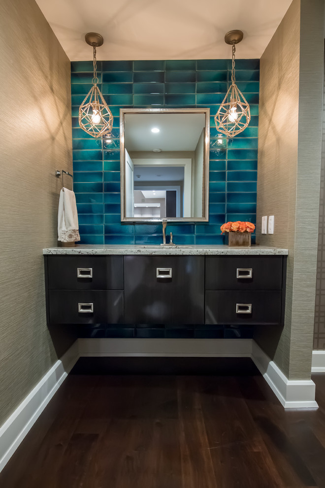 Classic cloakroom in Cleveland with flat-panel cabinets, brown cabinets, a one-piece toilet, blue tiles, ceramic tiles, grey walls, dark hardwood flooring, a submerged sink, granite worktops and brown floors.