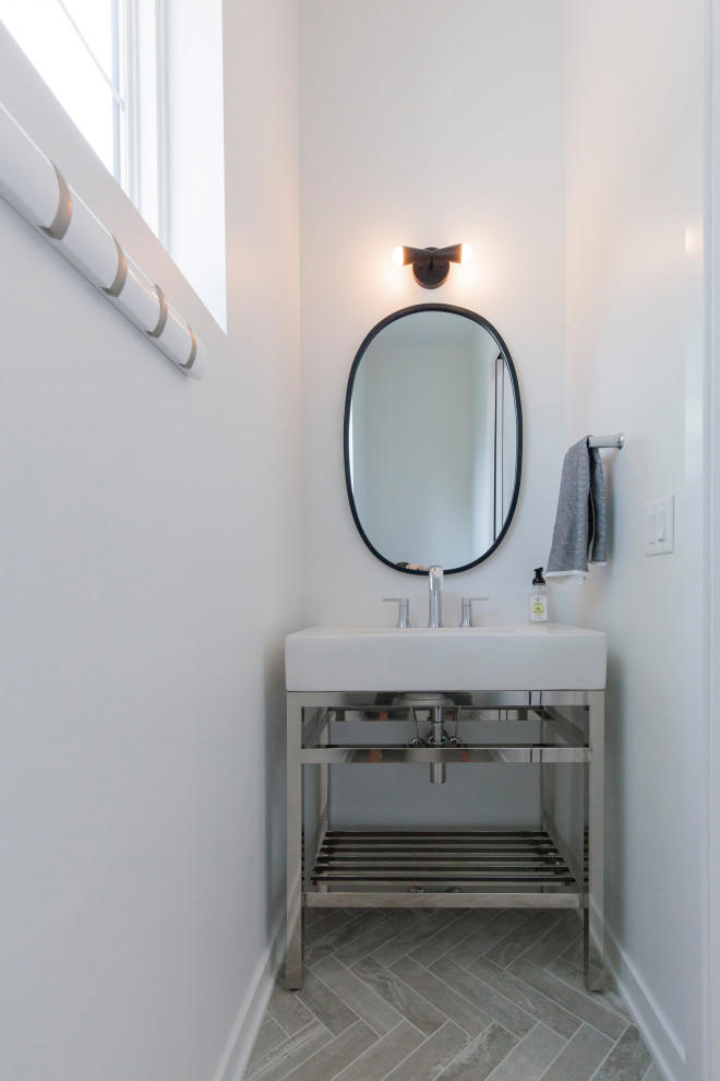 Exemple d'un grand WC et toilettes moderne avec des portes de placard blanches, un carrelage blanc, un mur blanc, un sol en carrelage de porcelaine, une vasque, un plan de toilette en acier inoxydable, un sol gris, un plan de toilette blanc et meuble-lavabo sur pied.