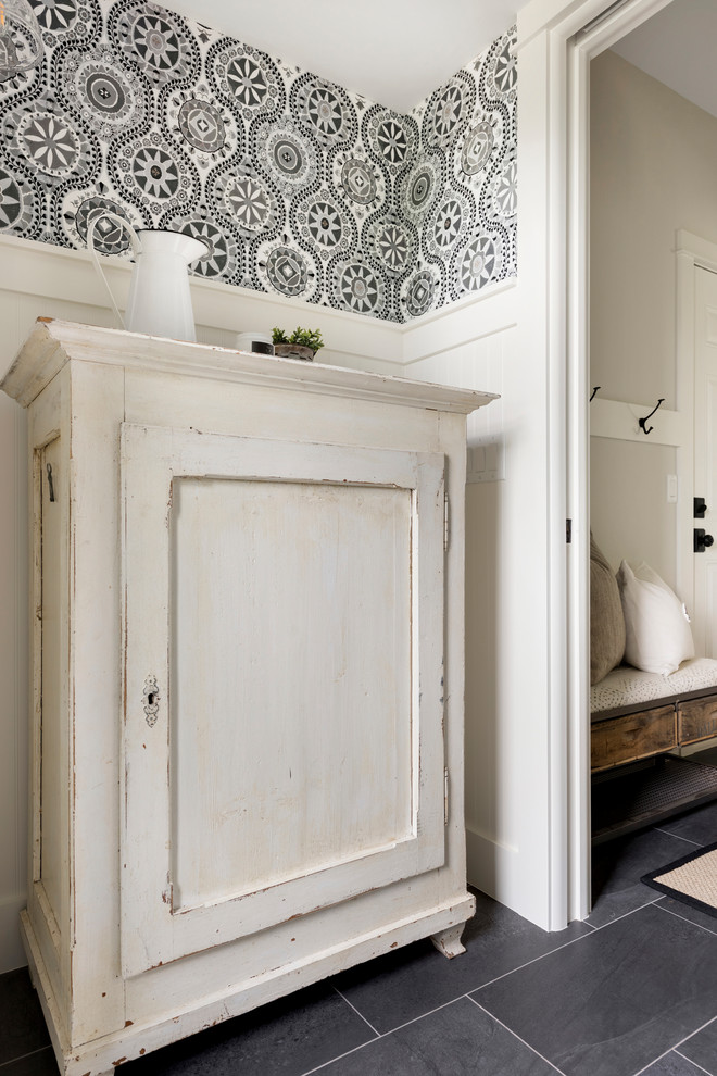 This is an example of a medium sized modern cloakroom in Minneapolis with freestanding cabinets, distressed cabinets, a one-piece toilet, yellow tiles, blue walls, a vessel sink, wooden worktops and brown worktops.