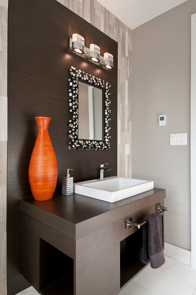 Inspiration for a contemporary gray tile and stone tile porcelain tile powder room remodel in Toronto with a vessel sink, flat-panel cabinets, dark wood cabinets, wood countertops, gray walls and brown countertops