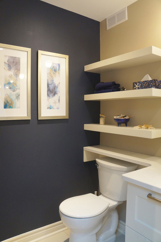 Small traditional cloakroom in Toronto with recessed-panel cabinets, white cabinets, a two-piece toilet, beige tiles, blue walls, a submerged sink and engineered stone worktops.