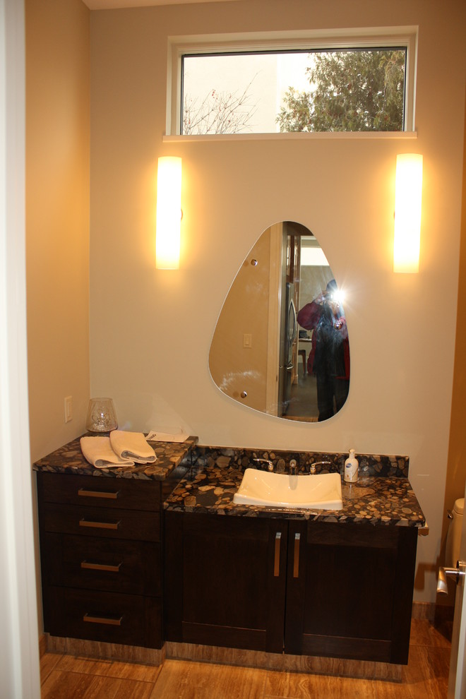 Photo of a small contemporary cloakroom in Edmonton with shaker cabinets, dark wood cabinets, a two-piece toilet, beige walls, porcelain flooring, a built-in sink and terrazzo worktops.