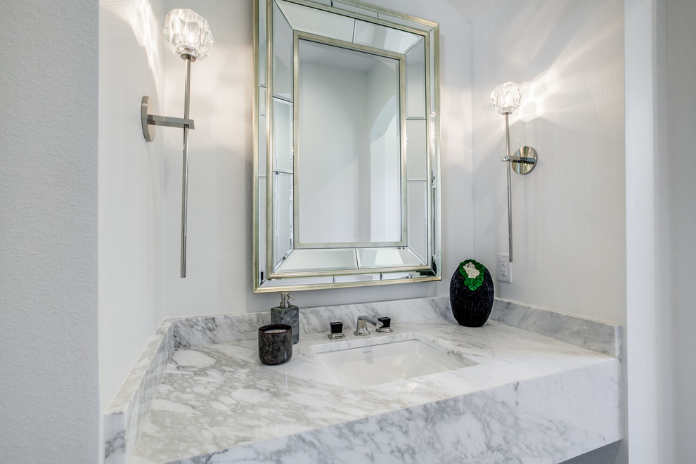 Inspiration for a medium sized mediterranean cloakroom in Dallas with a two-piece toilet, white tiles, marble tiles, white walls, marble flooring, a built-in sink, marble worktops, white floors and white worktops.