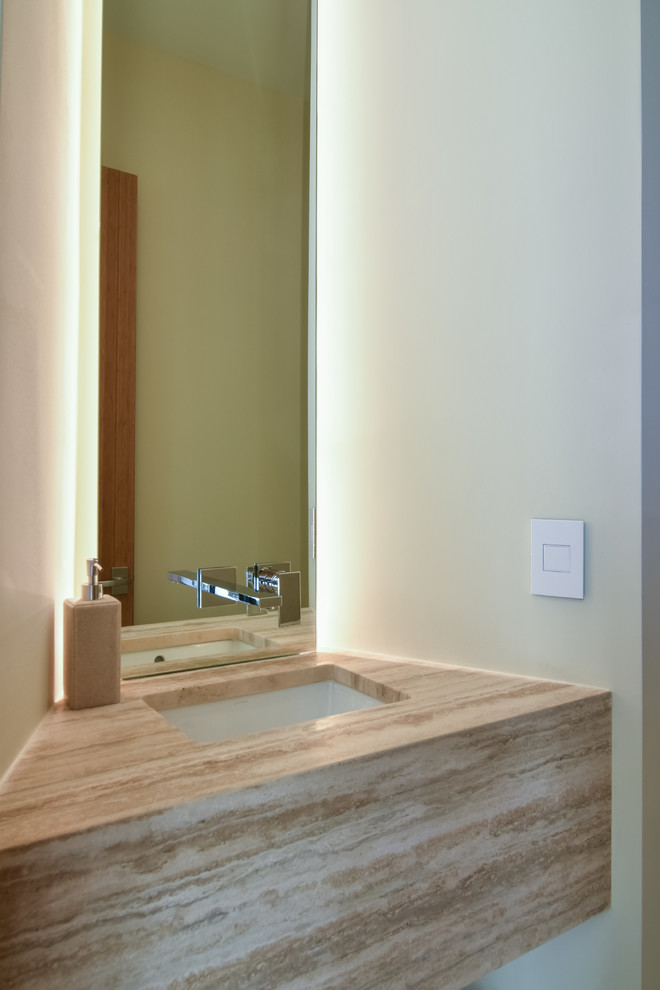 Moderne Gästetoilette mit offenen Schränken, weißer Wandfarbe, Porzellan-Bodenfliesen, Unterbauwaschbecken und Travertin-Waschtisch in Charleston