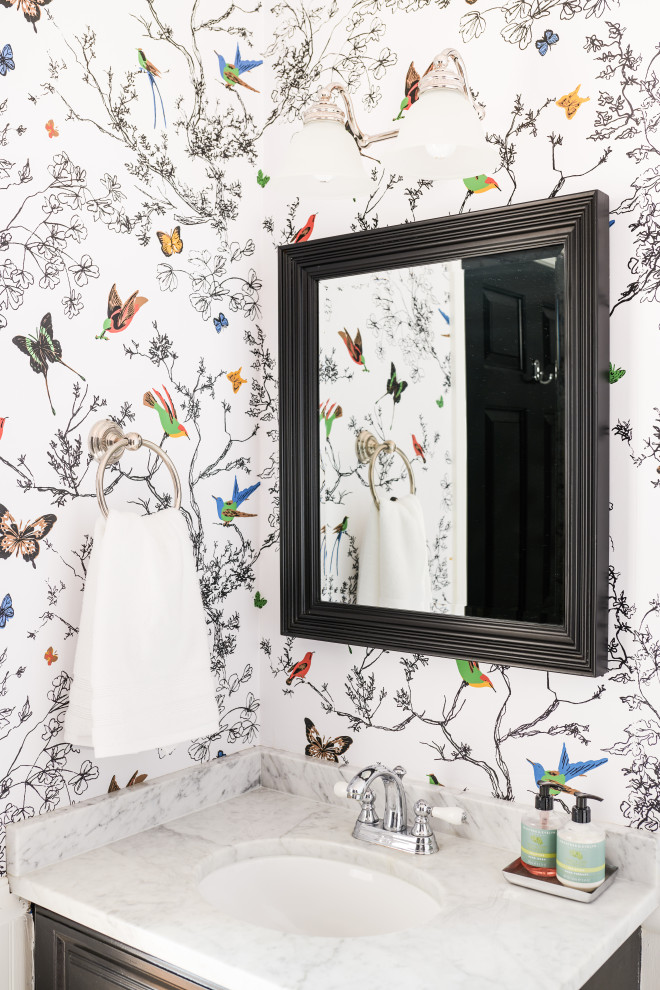 Inspiration for a small timeless ceramic tile and multicolored floor powder room remodel in Other with raised-panel cabinets, black cabinets, a two-piece toilet, multicolored walls, an undermount sink, marble countertops and gray countertops