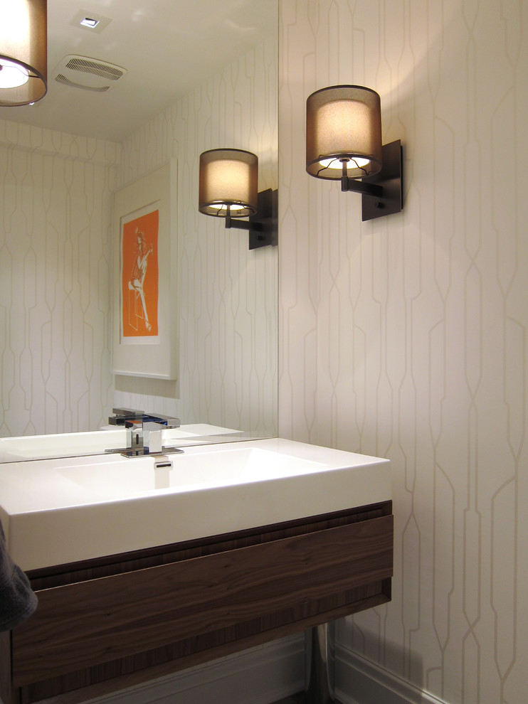 Inspiration for a transitional powder room remodel in Toronto with an integrated sink and dark wood cabinets