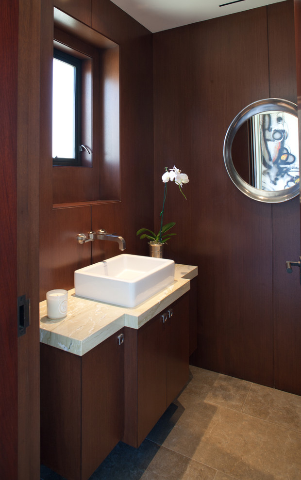 Photo of a small contemporary cloakroom in Orange County with a vessel sink, flat-panel cabinets, dark wood cabinets, brown walls and beige worktops.