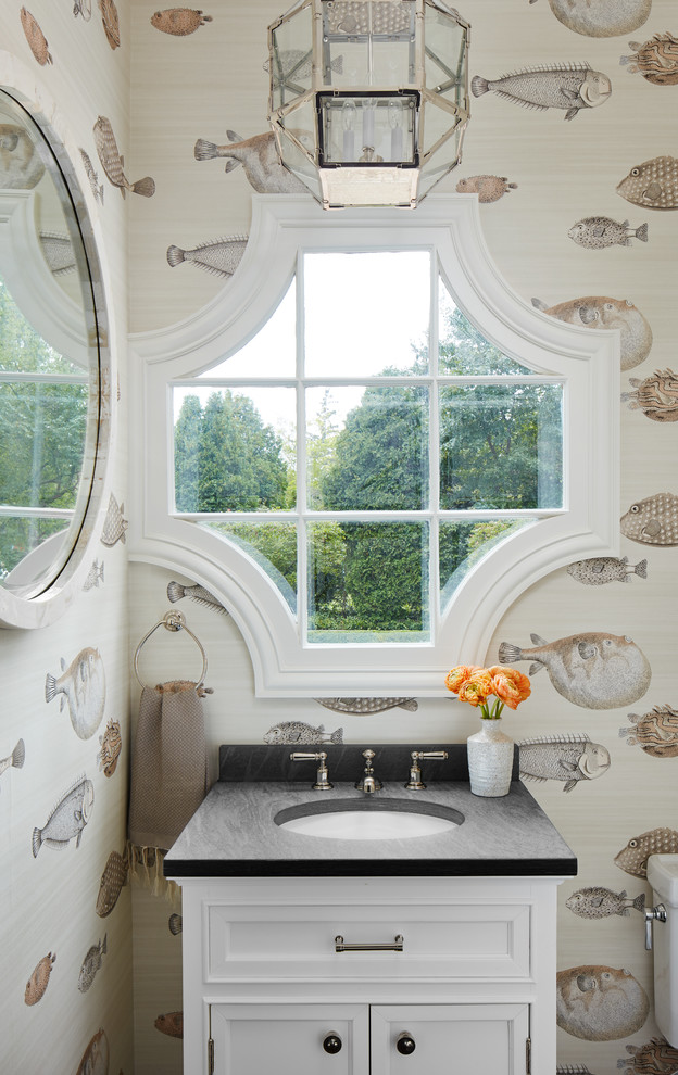 Example of a beach style powder room design in Chicago with recessed-panel cabinets, white cabinets, an undermount sink and gray countertops