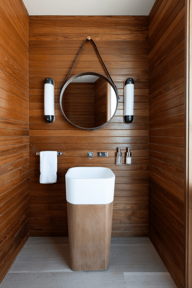 Design ideas for a nautical cloakroom in New York with brown walls, a pedestal sink and grey floors.