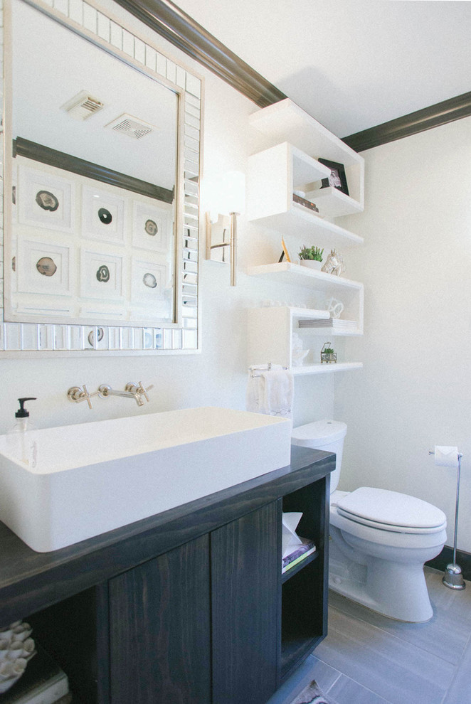 Design ideas for a medium sized classic cloakroom in Houston with flat-panel cabinets, dark wood cabinets, a two-piece toilet, grey tiles, porcelain tiles, white walls, porcelain flooring, a vessel sink and wooden worktops.