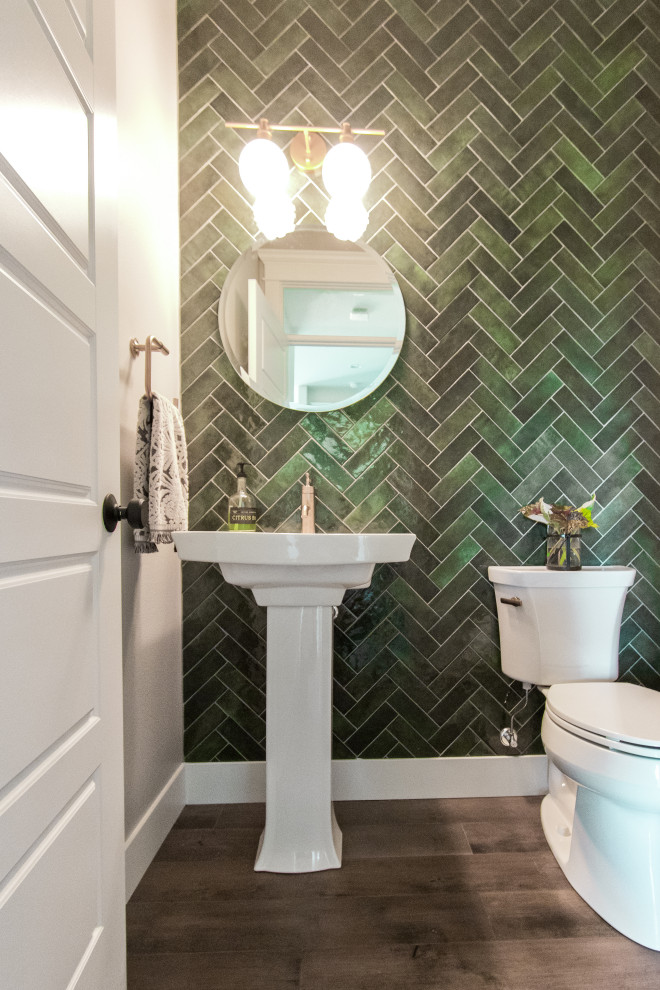 Small country cloakroom with a two-piece toilet, green tiles, a pedestal sink and a freestanding vanity unit.