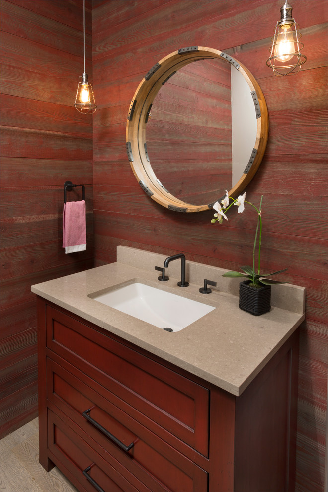 Medium sized traditional cloakroom in Denver with freestanding cabinets, dark wood cabinets, red walls, light hardwood flooring, a submerged sink, limestone worktops and brown floors.