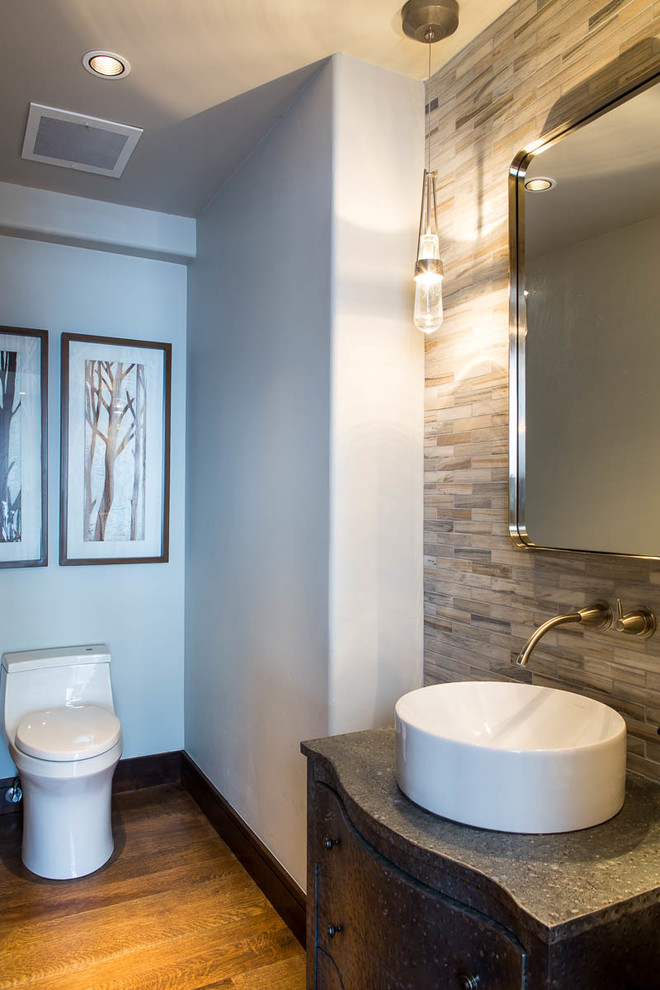 Mid-sized minimalist dark wood floor powder room photo in Denver with furniture-like cabinets, gray cabinets, a one-piece toilet, blue walls and a vessel sink
