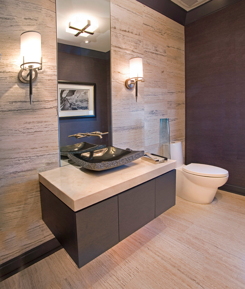 Example of a small trendy beige tile and porcelain tile porcelain tile and beige floor powder room design in Denver with a vessel sink, flat-panel cabinets, gray cabinets, a one-piece toilet, beige walls, quartz countertops and beige countertops
