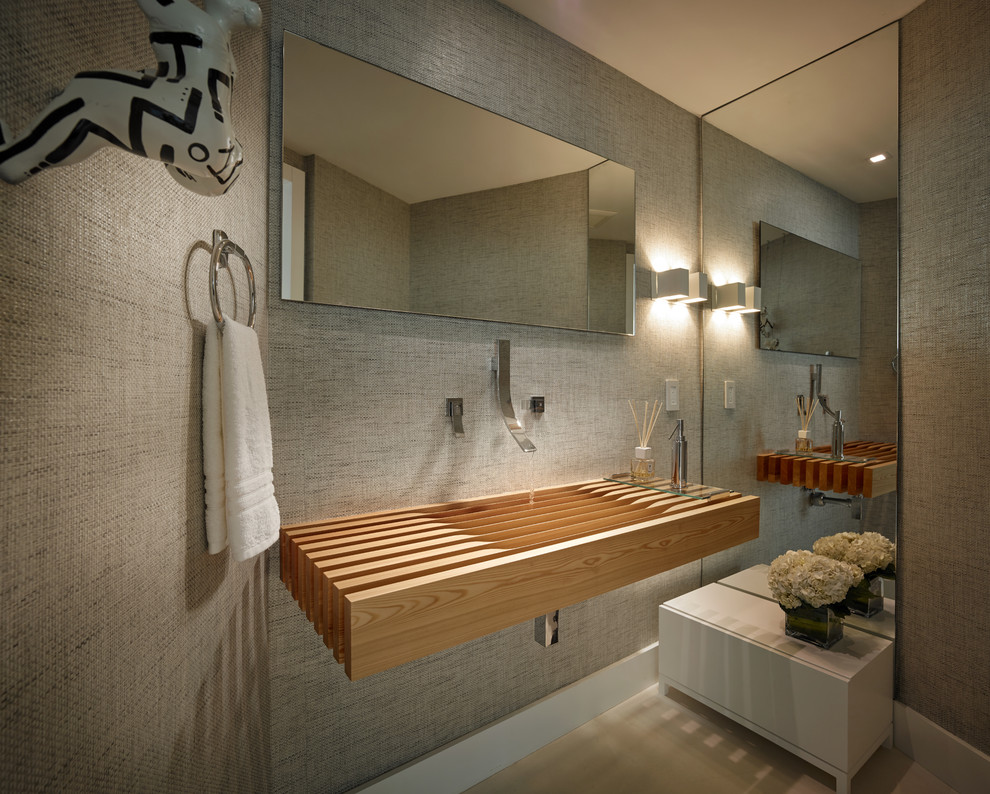 This is an example of a small contemporary cloakroom in Miami with grey walls, porcelain flooring, an integrated sink, wooden worktops, beige floors and brown worktops.