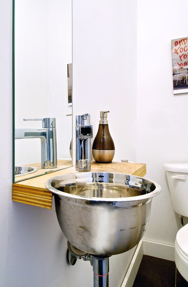 Пример оригинального дизайна: туалет в стиле лофт с столешницей из дерева, накладной раковиной и коричневой столешницей