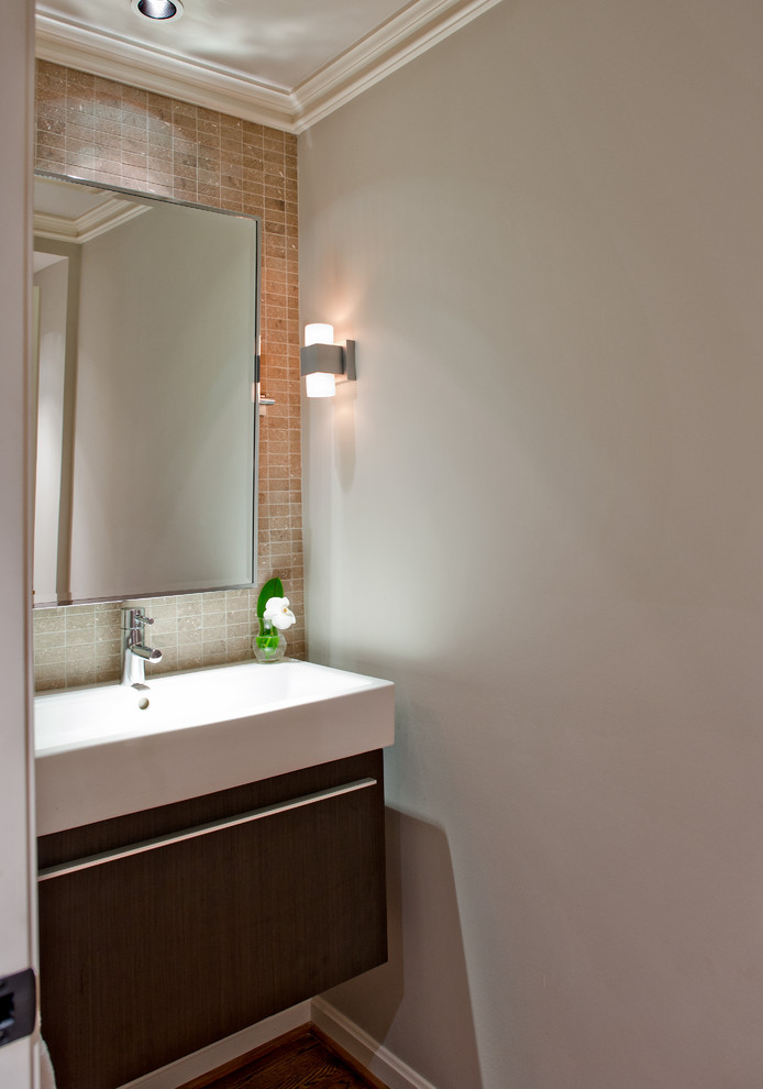 Example of a mid-sized transitional beige tile and stone tile medium tone wood floor powder room design in Nashville with a wall-mount sink, flat-panel cabinets, dark wood cabinets, a one-piece toilet and gray walls