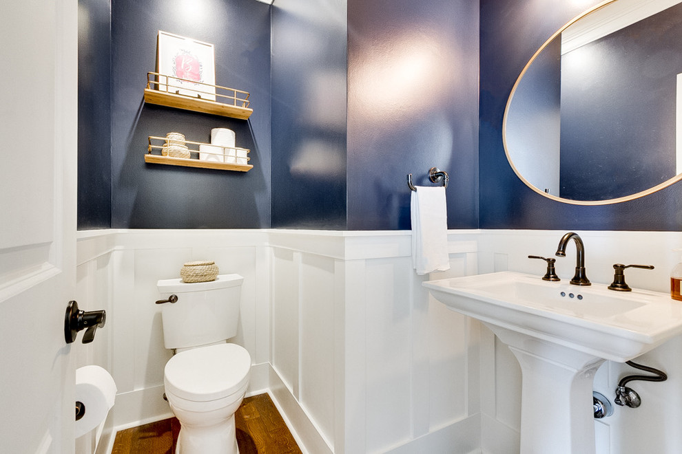 Inspiration for a small traditional cloakroom in Dallas with shaker cabinets, white cabinets, a two-piece toilet, white tiles, blue walls, dark hardwood flooring, a pedestal sink, brown floors and white worktops.