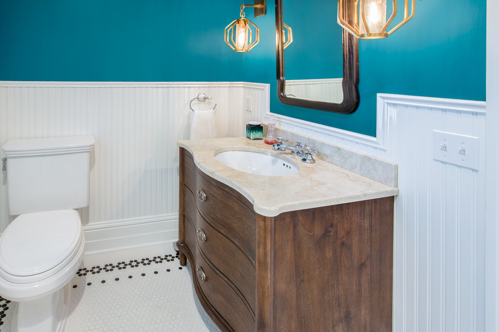 Cette photo montre un WC et toilettes chic en bois foncé de taille moyenne avec un placard en trompe-l'oeil, WC séparés, un mur bleu, un sol en carrelage de terre cuite, un lavabo encastré, un plan de toilette en marbre, un sol blanc et un plan de toilette beige.