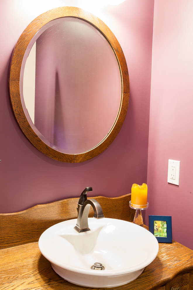 Small traditional cloakroom in Boston with medium wood cabinets, purple walls, wooden worktops and a vessel sink.