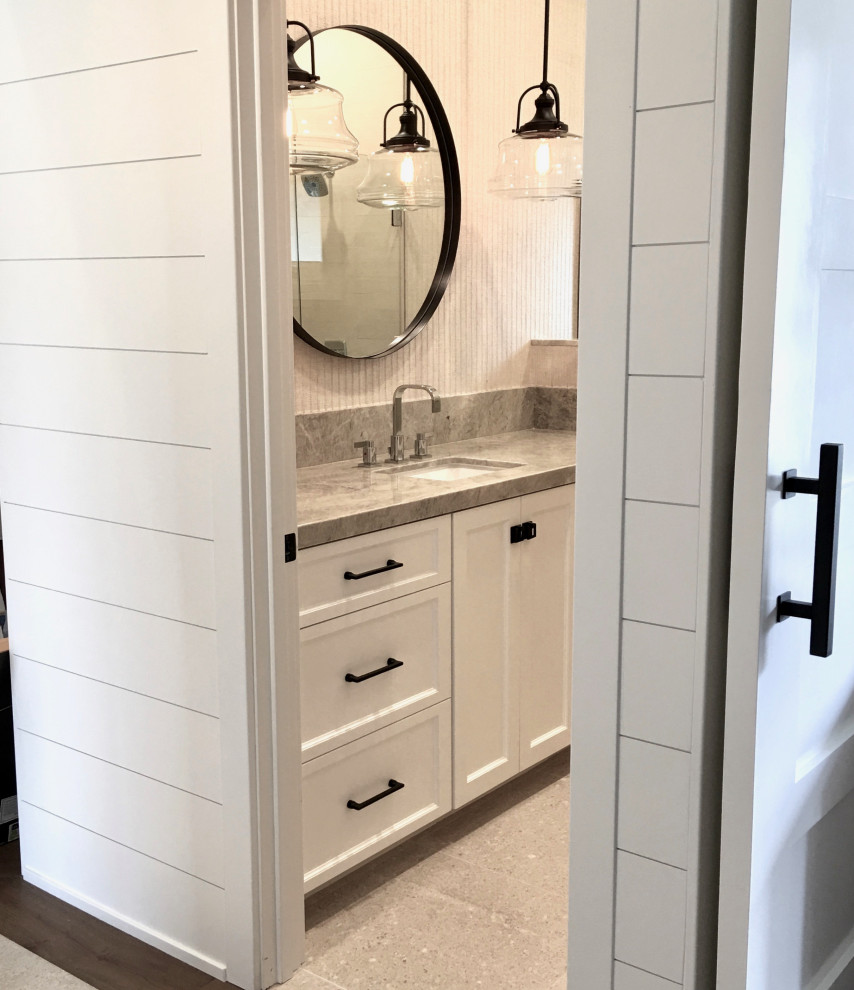 Photo of a country cloakroom in Orange County with shaker cabinets, white cabinets, beige tiles, beige walls, limestone flooring, a built-in sink, quartz worktops, beige floors, beige worktops, a built in vanity unit and wallpapered walls.