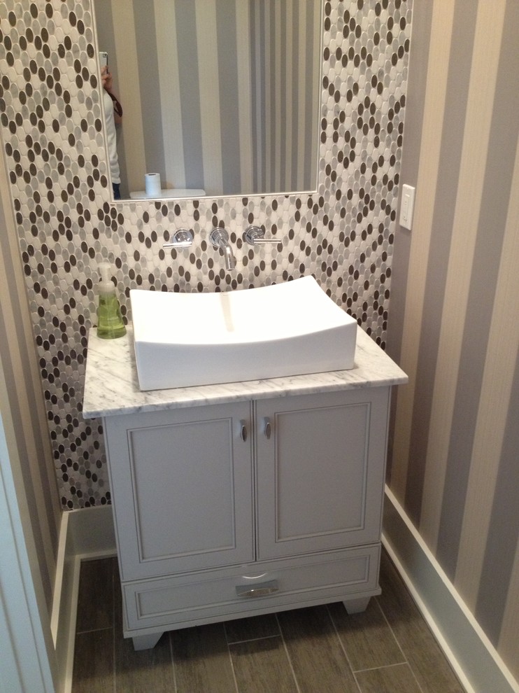 Inspiration for a transitional multicolored tile and mosaic tile powder room remodel in New Orleans with a vessel sink, flat-panel cabinets, white cabinets and marble countertops