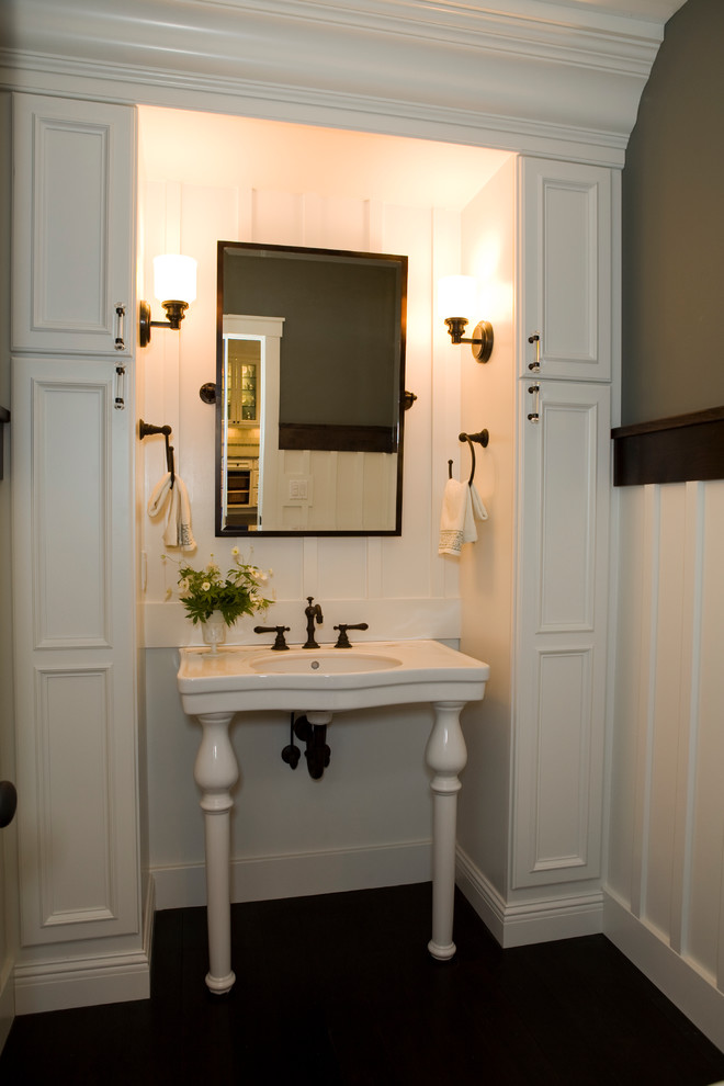 Photo of a classic cloakroom in Other with white cabinets and a console sink.