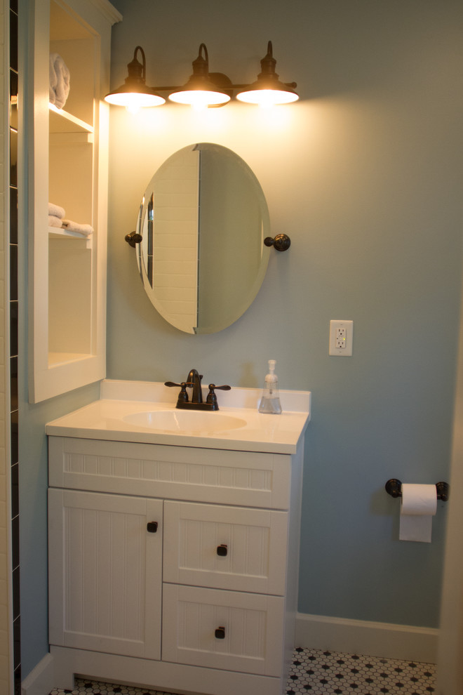 インディアナポリスにある広いトラディショナルスタイルのおしゃれなトイレ・洗面所 (インセット扉のキャビネット、緑のキャビネット、ラミネートの床、茶色い床) の写真