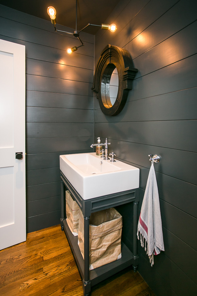 Photo of a medium sized traditional cloakroom in Providence with black walls and medium hardwood flooring.