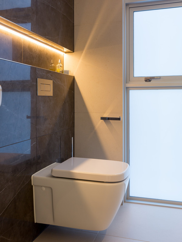 Modern cloakroom in Brisbane with open cabinets, a wall mounted toilet, porcelain tiles, white walls and porcelain flooring.