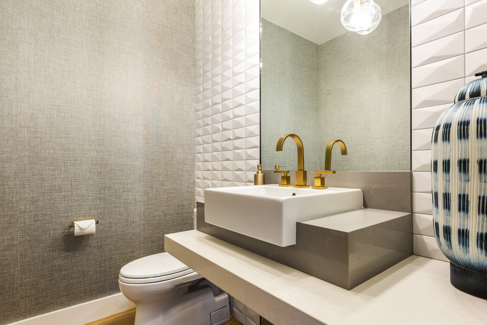 Design ideas for a medium sized contemporary cloakroom in Other with open cabinets, white cabinets, a two-piece toilet, white tiles, ceramic tiles, grey walls, medium hardwood flooring, a vessel sink, engineered stone worktops, brown floors and white worktops.