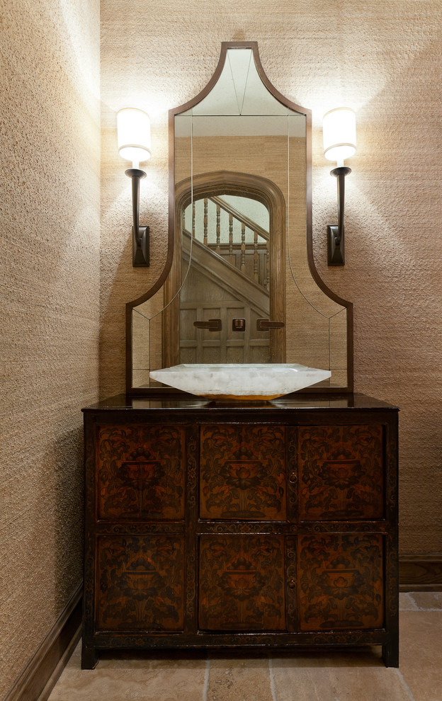 Foto di un bagno di servizio etnico con lavabo a bacinella, consolle stile comò, ante in legno bruno e pareti beige