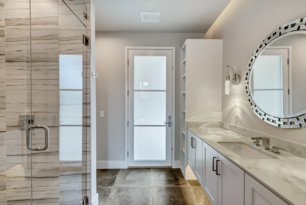 Inspiration for a transitional porcelain tile, gray tile and white tile porcelain tile bathroom remodel in Dallas with shaker cabinets, white cabinets, gray walls and quartz countertops