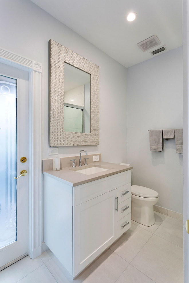 Photo of a medium sized traditional cloakroom in Miami with shaker cabinets, white cabinets, a one-piece toilet, yellow tiles, mosaic tiles, grey walls, ceramic flooring, a submerged sink, laminate worktops, multi-coloured floors and beige worktops.