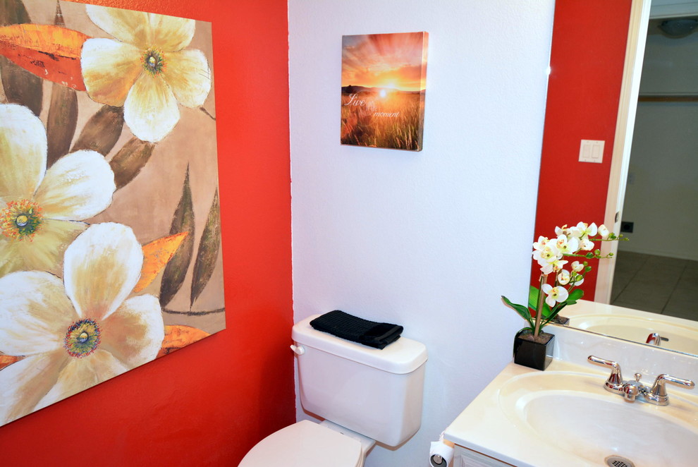 Powder room - small traditional beige tile and ceramic tile ceramic tile powder room idea in Albuquerque with an integrated sink, a two-piece toilet and red walls