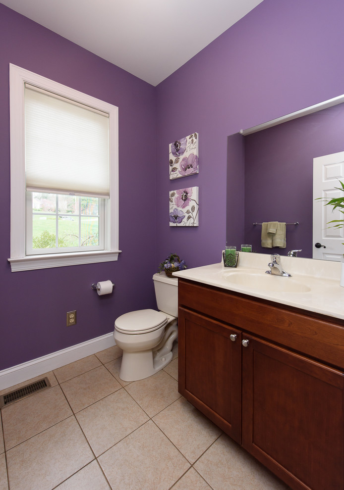 Elegant porcelain tile powder room photo in Philadelphia with granite countertops and purple walls