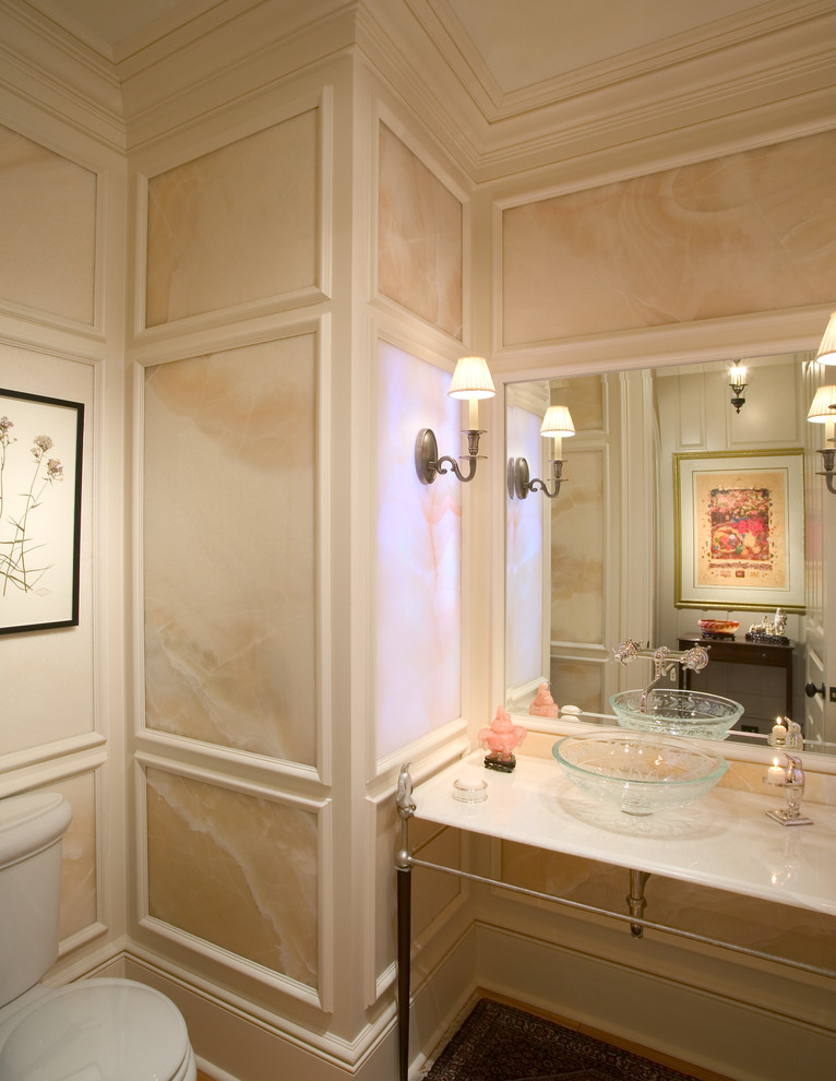 Example of a small ornate stone slab powder room design in Charleston with a vessel sink, onyx countertops, a two-piece toilet and beige walls