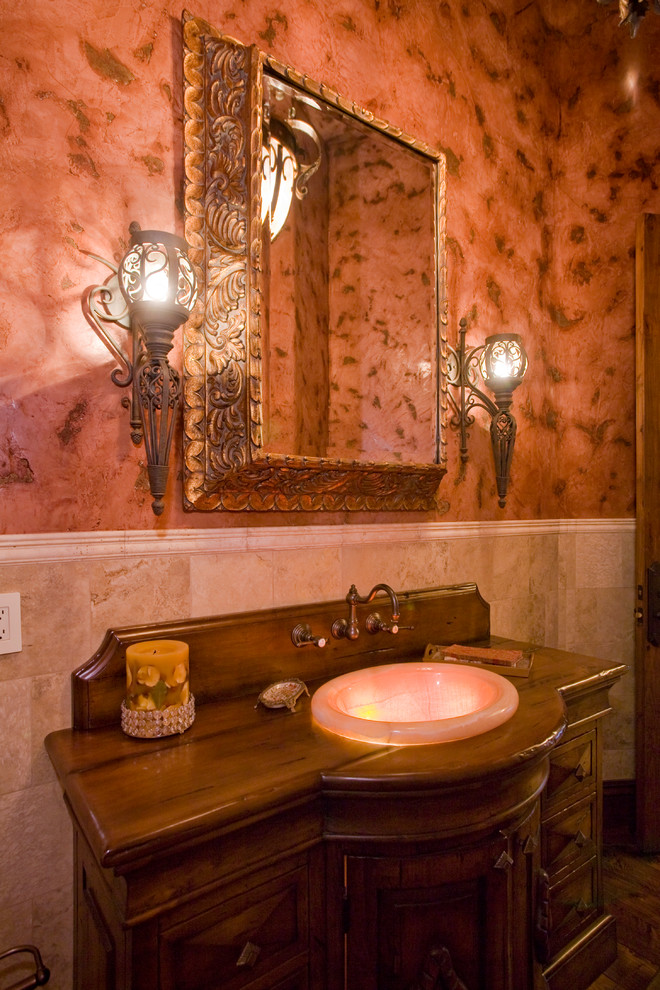 Example of a tuscan powder room design in Phoenix