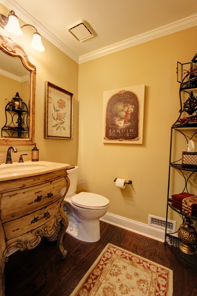 Photo of a small traditional cloakroom in Atlanta with a submerged sink, freestanding cabinets, distressed cabinets, granite worktops, a one-piece toilet, yellow walls and medium hardwood flooring.