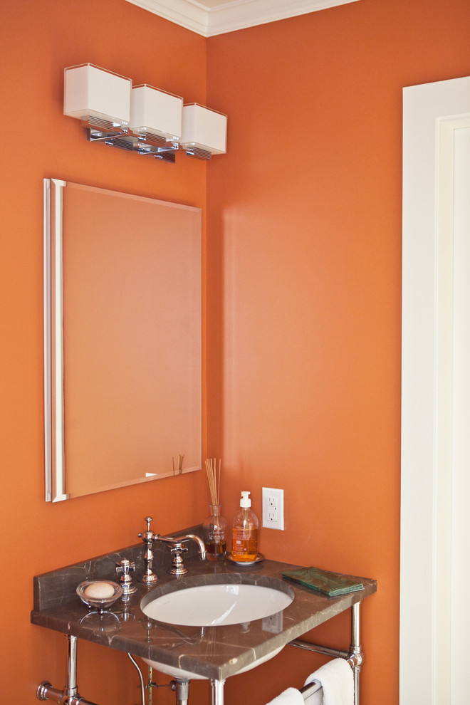 На фото: туалет в классическом стиле с врезной раковиной, столешницей из гранита и оранжевыми стенами с