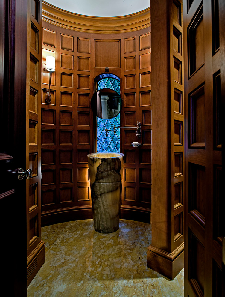 Powder room - mid-sized traditional marble floor powder room idea in Detroit with a pedestal sink, medium tone wood cabinets, onyx countertops and brown walls