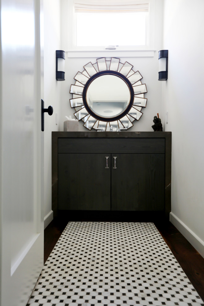 Large urban white tile powder room photo in San Diego with flat-panel cabinets, marble countertops, a two-piece toilet, an undermount sink, white walls and dark wood cabinets