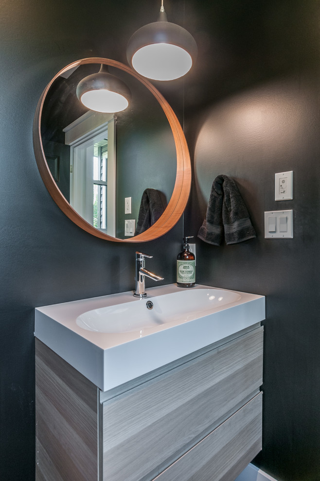 Inspiration for a medium sized cloakroom in Toronto with light wood cabinets, a one-piece toilet, grey walls and an integrated sink.