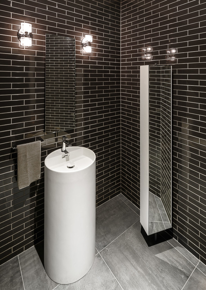 Cette image montre un WC et toilettes design avec un lavabo de ferme et un carrelage noir.